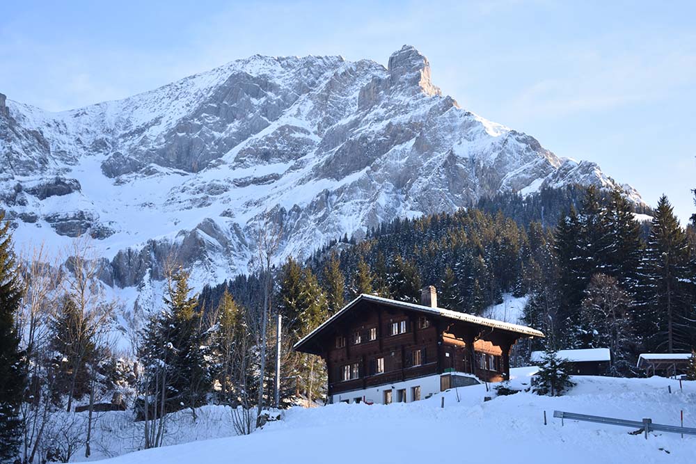 Chalet in snow with mountain behind