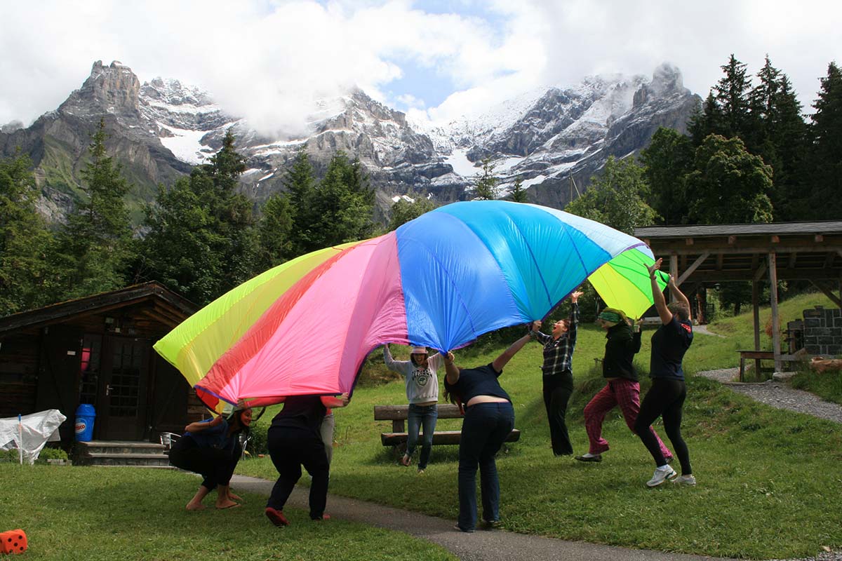 group playing with a colorful parachute