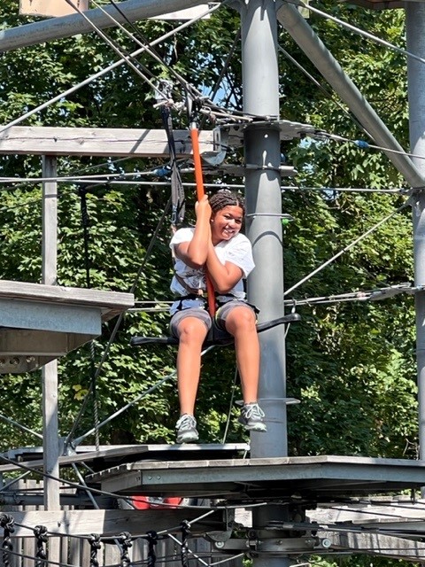 A young girl on a climbing tower element