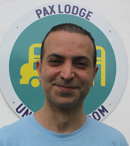 Amir in front of a Pax Lodge Icon