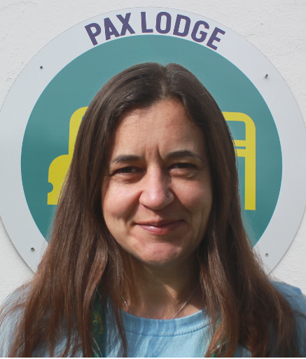 Liz in front of a Pax Lodge Icon