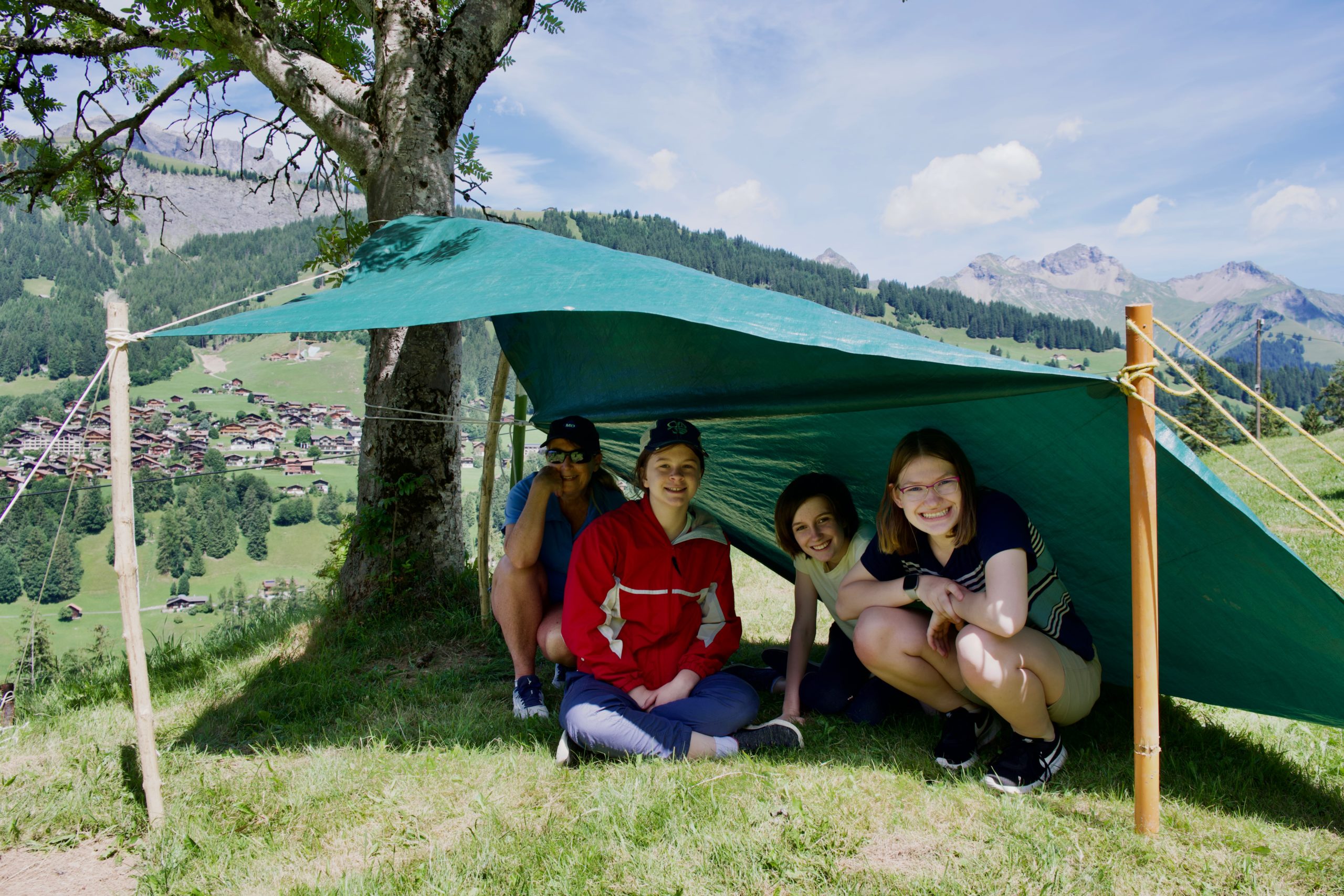 Girl Scouts under camp shelter